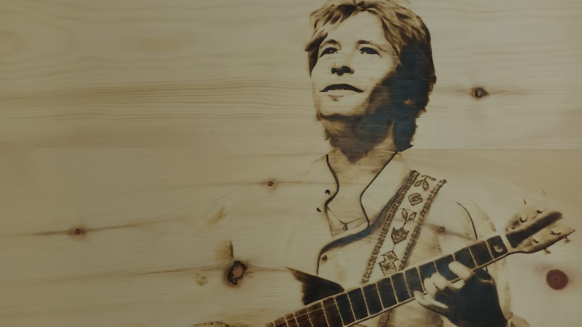John Denver. Ritratto di John Denver su legno di cirmolo. Pirografia, 2023.. Pirografia, 2023